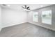 Bright bedroom with two windows and ceiling fan at 206 S Water St, Plant City, FL 33563