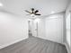 Bright bedroom with ceiling fan, gray flooring, and double door closet at 206 S Water St, Plant City, FL 33563