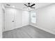 Spacious bedroom with ceiling fan and gray vinyl flooring at 206 S Water St, Plant City, FL 33563