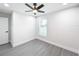 Spacious bedroom with ceiling fan and grey flooring at 206 S Water St, Plant City, FL 33563
