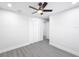Bedroom with ceiling fan, grey floors, and built-in closet at 206 S Water St, Plant City, FL 33563