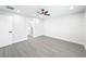 Bright bedroom with ceiling fan and grey wood-look floors at 206 S Water St, Plant City, FL 33563