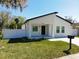 Newly built home with white exterior, fenced yard, and driveway at 206 S Water St, Plant City, FL 33563