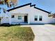 Modern white house with black accents, landscaped lawn, and driveway at 206 S Water St, Plant City, FL 33563