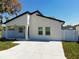 Contemporary home with white exterior, black trim, and a spacious yard at 206 S Water St, Plant City, FL 33563
