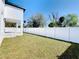 Single story house with backyard, white fence, and covered patio at 206 S Water St, Plant City, FL 33563