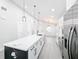 Modern kitchen with white cabinets, quartz countertops, and stainless steel appliances at 206 S Water St, Plant City, FL 33563
