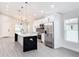 Modern kitchen with white cabinets, quartz countertops, and stainless steel appliances at 206 S Water St, Plant City, FL 33563