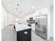 Modern kitchen with white cabinets, quartz countertops, and stainless steel appliances at 206 S Water St, Plant City, FL 33563