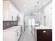 Modern kitchen with white cabinets, quartz countertops, and stainless steel appliances at 206 S Water St, Plant City, FL 33563