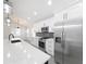Modern kitchen with white cabinets, quartz countertops, and stainless steel appliances at 206 S Water St, Plant City, FL 33563