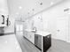 Modern kitchen with white cabinets, quartz countertops, and stainless steel appliances at 206 S Water St, Plant City, FL 33563