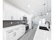 Modern kitchen with white cabinets, quartz countertops, and stainless steel appliances at 206 S Water St, Plant City, FL 33563