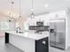 Modern kitchen with white cabinets, quartz countertops, and stainless steel appliances at 206 S Water St, Plant City, FL 33563