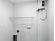 Laundry room features a tankless water heater and wire shelving at 206 S Water St, Plant City, FL 33563
