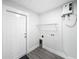 Laundry room with shelving, tankless water heater, and vinyl flooring at 206 S Water St, Plant City, FL 33563