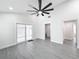 Bright living room with vinyl flooring, ceiling fan, and sliding glass doors at 206 S Water St, Plant City, FL 33563