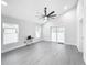 Bright living room with gray vinyl flooring and sliding glass doors leading to patio at 206 S Water St, Plant City, FL 33563