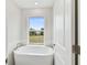 Soaking tub with large window and modern fixtures at 2607 N 21St St, Tampa, FL 33605