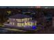 Modern home with a pool and city skyline view at night at 5032 W Longfellow Ave, Tampa, FL 33629