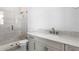 Bathroom with gray vanity, marble countertop, and a walk-in shower at 5032 W Longfellow Ave, Tampa, FL 33629
