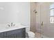 Modern bathroom with gray vanity and frameless shower at 5032 W Longfellow Ave, Tampa, FL 33629