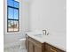 Modern bathroom with a freestanding soaking tub, marble flooring, and a large window at 5032 W Longfellow Ave, Tampa, FL 33629