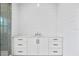 Bathroom with white cabinets, marble countertop, and a walk-in shower at 5032 W Longfellow Ave, Tampa, FL 33629