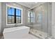 Luxury bathroom with gray tile, a soaking tub, and a large shower at 5032 W Longfellow Ave, Tampa, FL 33629