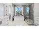 Elegant bathroom with white cabinets, marble countertops, and a soaking tub at 5032 W Longfellow Ave, Tampa, FL 33629