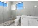 Modern bathroom with a glass shower, white vanity, and marble countertop at 5032 W Longfellow Ave, Tampa, FL 33629