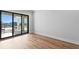 Bedroom with hardwood floors and sliding glass doors to a balcony at 5032 W Longfellow Ave, Tampa, FL 33629