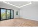 Bright bedroom with hardwood floors and sliding glass doors to balcony at 5032 W Longfellow Ave, Tampa, FL 33629