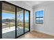 Bedroom with hardwood floors and sliding glass doors opening to a balcony overlooking the water at 5032 W Longfellow Ave, Tampa, FL 33629