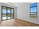 Bright bedroom with hardwood floors and sliding glass doors to patio at 5032 W Longfellow Ave, Tampa, FL 33629