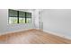 Light and airy bedroom featuring hardwood floors and large window at 5032 W Longfellow Ave, Tampa, FL 33629