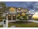 Stunning two-story home with a three-car garage and attractive landscaping at 5032 W Longfellow Ave, Tampa, FL 33629