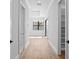 Bright hallway with hardwood floors and access to bedrooms and closets at 5032 W Longfellow Ave, Tampa, FL 33629
