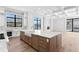 Open concept kitchen with large island and hardwood floors at 5032 W Longfellow Ave, Tampa, FL 33629
