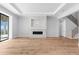 Spacious living room with hardwood floors, fireplace, and high ceilings at 5032 W Longfellow Ave, Tampa, FL 33629