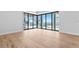 Bright living room with hardwood floors and sliding glass doors leading to a pool and water view at 5032 W Longfellow Ave, Tampa, FL 33629