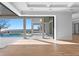 Living area with hardwood floors and access to a pool and patio overlooking the water at 5032 W Longfellow Ave, Tampa, FL 33629
