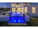 Stunning pool and waterfall feature with blue lighting at night at 5032 W Longfellow Ave, Tampa, FL 33629