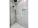 Modern shower with gray marble tile and gold fixtures at 5032 W Longfellow Ave, Tampa, FL 33629