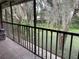 Long screened in porch has a view of the exterior yard with several large trees at 6010 Laketree Ln # L, Temple Terrace, FL 33617