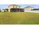 Large backyard with screened patio and grassy area at 14953 Flowing Gold Dr, Bradenton, FL 34212