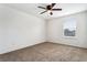 Well-lit bedroom with ceiling fan, carpet, and window with blinds at 605 19Th Nw St, Ruskin, FL 33570