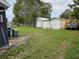 Large backyard with wooden fence and multiple storage sheds at 1006 39Th W Ave, Bradenton, FL 34205