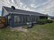 House with screened patio, surrounded by landscaping and a spacious backyard at 1006 39Th W Ave, Bradenton, FL 34205