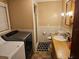 Bathroom with shower, toilet, vanity, and washer/dryer at 1006 39Th W Ave, Bradenton, FL 34205